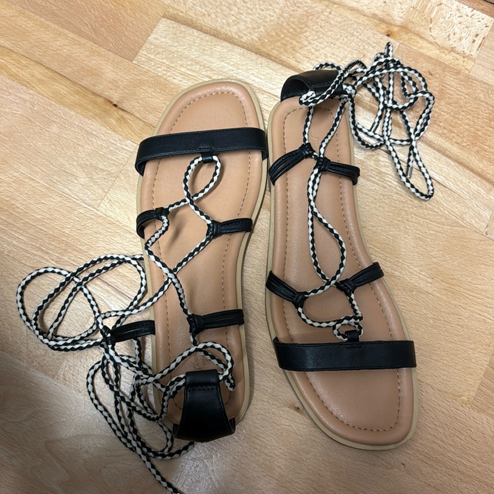 Lightly worn black/white women’s sandals size 12 with long ankle ties